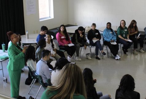 Students and teachers sit in a circle in the Student Commons for Study Circles as admin Nicole Morgan speaks. Over 40 students and staff participated in the October two-day retreat.