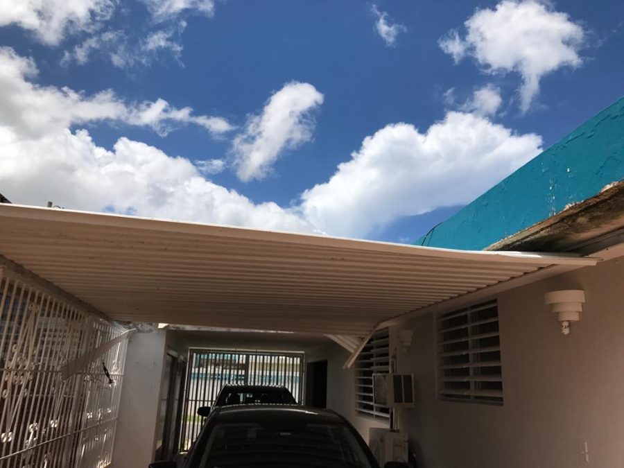 Cruzs cars sit in the garage, which had its roof ripped off in the storm. His house was one of hundreds of thousands of homes on the island that were damaged or destroyed by the hurricane.