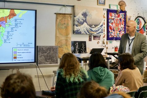 AP US History teacher Nathan Schwartz delivers a lecture to his class per the College Board curriculum. AP students learn the important skill of note-taking from these college-level lectures.