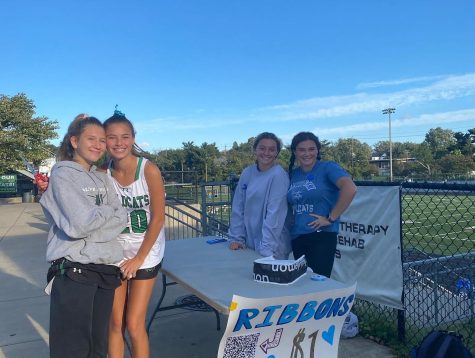 Juniors Hillevi Schine, Natalya Krouse, Anna Zucconi and senior Olivia Israel sell ribbons during a One Love club fundraiser at a field hockey game. The light blue ribbons sold for $1 contributed to the fundraiser total of $4,136.