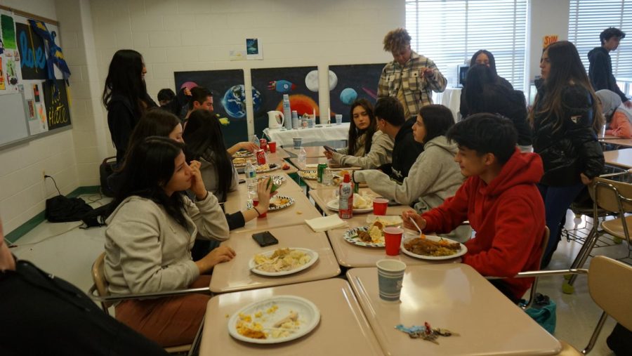 Students celebrate together at the International Clubs Thanksgiving event. Its amazing. The food is so good. [Celebrating at school] is so great. The environment, people talking and conversing, junior Kabir Singh said.