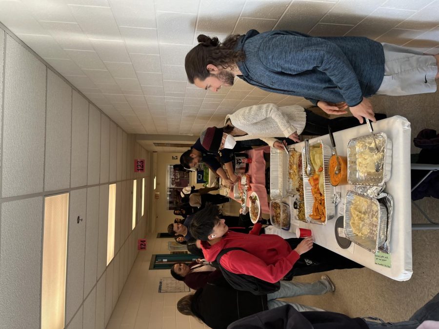 Junior Noah Carrasco gathers Thanksgiving food to put on his plate during the event. “I think it’s great for these kids that aren’t as familiar with American culture, to learn about it, because this is something that I cherish a lot. [Thanksgiving] is my favorite holiday, Carrasco said.