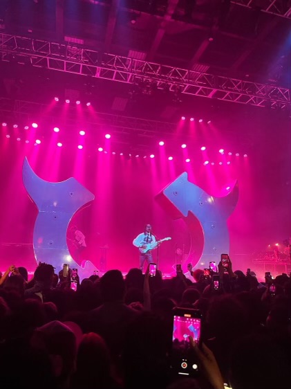 Steve Lacy performs in front of an enlarged logo from his recent Gemini Rights album as many in the crowd record him. Lacy has exploded in popularity since the release of his hit song Bad Habit after half a decade as a well-known indie darling.