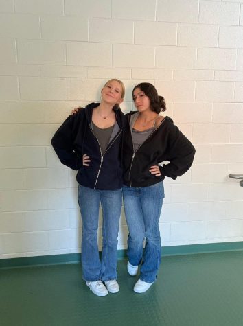 Sophomores Ariel Mazor and Claire Kuemmerle show their team spirit before the varsity volleyball game by dressing up for twin day.