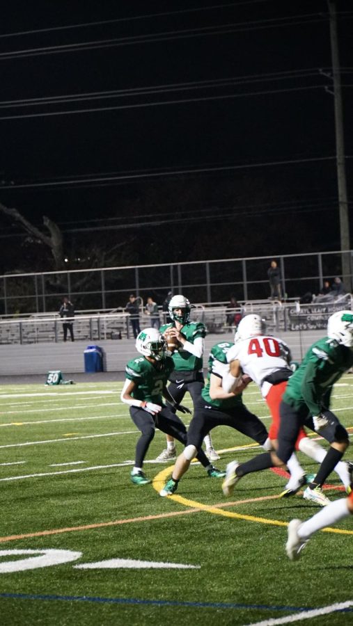 Junior quarterback Charlie Blessing looks to pass the ball. The offense was very successful both running and passing the ball against the Patriots.