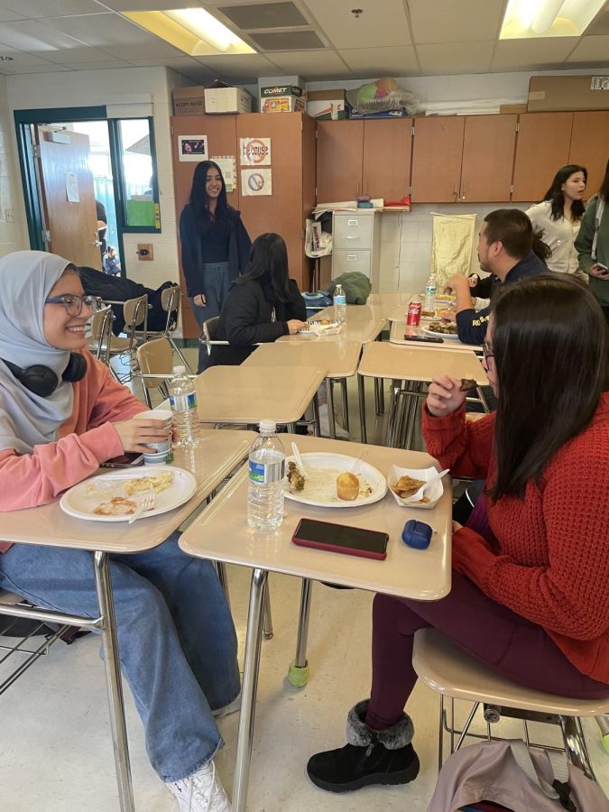 Seniors Saima Waziri and Renelyn Sabangan enjoy the International Club Thanksgiving lunch. Its very good, so people from other countries can experience American culture, be more involved and not be alone and be together, Waziri said.