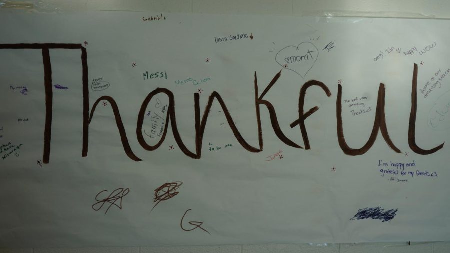 Students+from+International+Club+create+a+mural+on+the+white+board+for+all+the+things+they+are+thankful+for.+For+students+who+have+just+moved+to+the+US%2C+like+sophomore+Camila+Hernandez%2C+this+event+has+shown+them+what+the+holiday+is+all+about.+%E2%80%9CI%E2%80%99m+from+Colombia%3B+it%E2%80%99s+my+first+Thanksgiving.+%5BThis+event%5D+makes+me+know+how+they+celebrate+because+I+dont+know+anything+about+%5BThanksgiving%5D%2C%E2%80%9D+Hernandez+said.