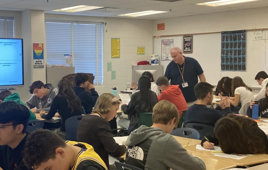 Teacher Fredrick Delello assists his AP Government students as they work on an assignment.