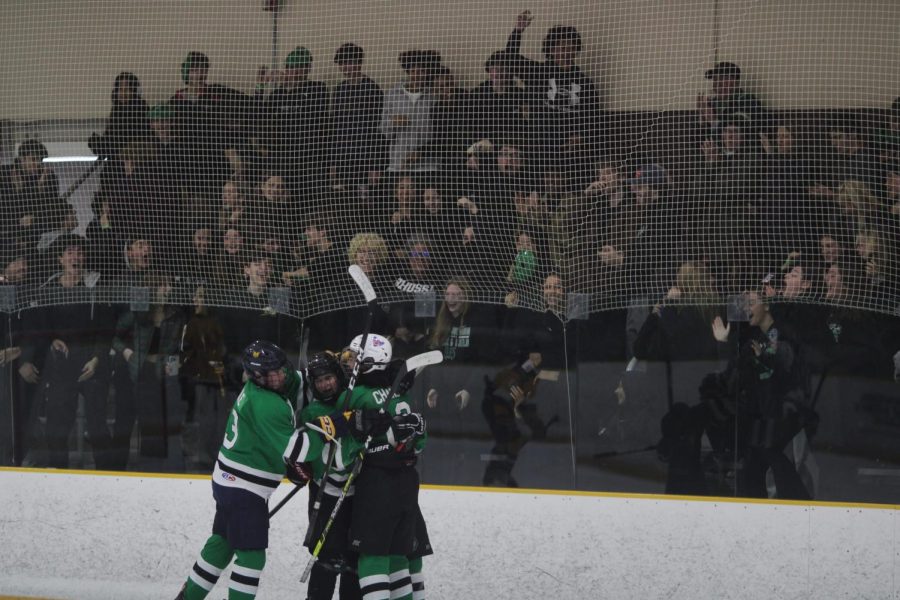 Icecats swarm Alex Chang to celebrate in front of a full crowd decked out in black. Even though they were in the process of killing off a penalty, Chang was able to put one past BCCs goalie.