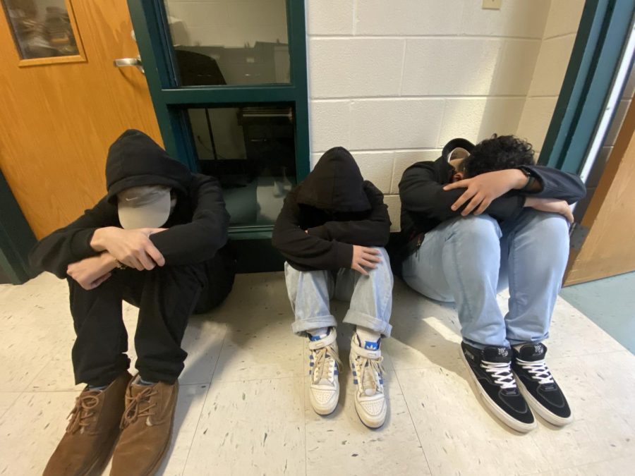 Freshman Jason Carcamo, Ahrin Letourneau and Brian Tudor participate in the safety training drills. They practiced their severe weather drill, where students must find shelter in hallways with no windows near by.