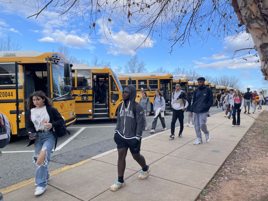 Students walk to their respective buses after a day of school. Buses have been missing many times this year, leaving students to find alternative ways home.