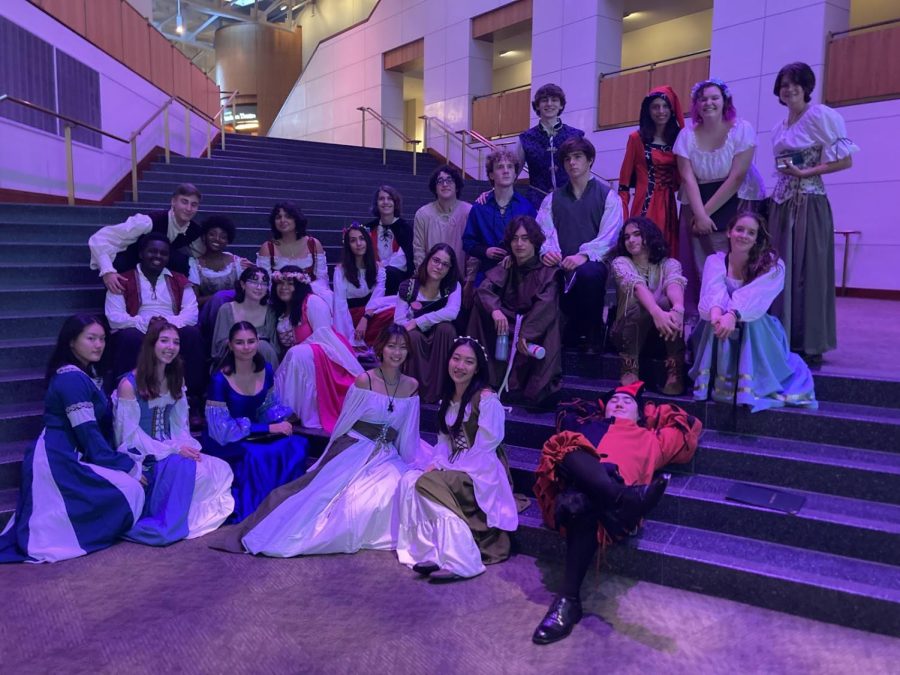 The Madrigals pose inside a University of Maryland staircase, relaxing ahead of their collaborative performance. We were standing out in our Renaissance outfits, everyone else had their uniforms and black dress on; we were really extravagant, sophomore Saku Tanaka said.