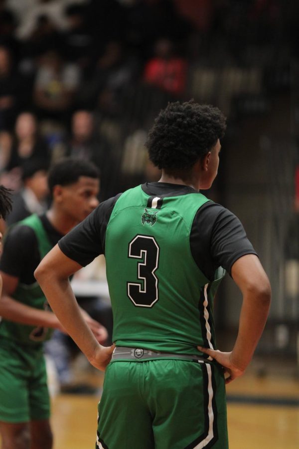 Senior captain Christion Wright lines up as Blake Baily shoots free throws. The Wildcats are now 2-1 entering the game Friday night against Blair.