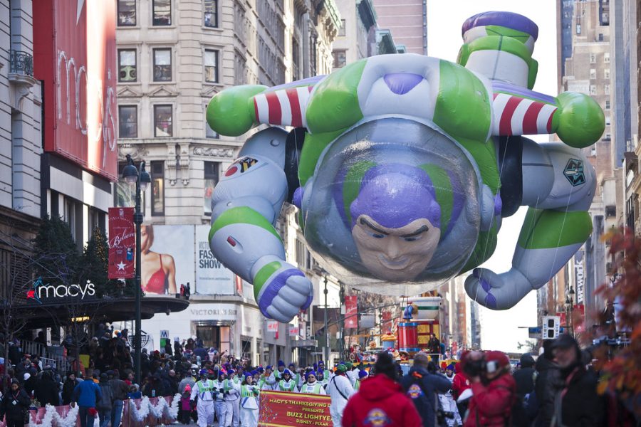 A Buzz Lightyear inflatable floats above a crowd of spectators in Macys annual Thanksgiving Parade. Hundreds of thousands of people watch the parade each year, which is composed of a multitude of balloons from many different companies.