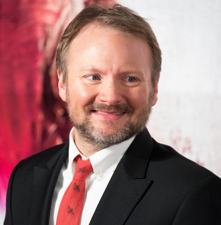 Glass Onion: A Knives Out Mystery writer, director and producer Rian Johnson attends a red carpet movie premiere. Johnson was contracted to create a second and third film in the mystery franchise after Netflix purchased the rights to the series in 2021.