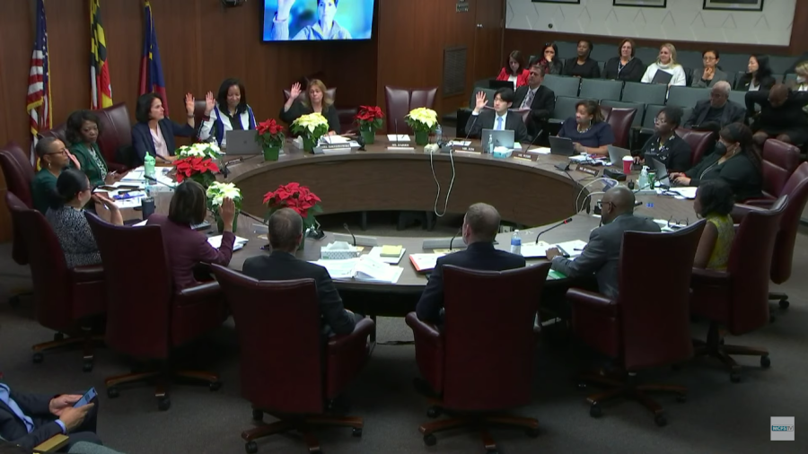 Board members raise their hands in support of the proposal for next years calendar. The calendar will have an Aug. 28 first day and June 13 last day.