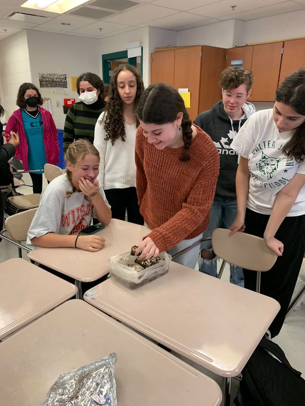 Members share and enjoy brownies at a Bake with Kindness meeting. The club aims to give back to the community through baking together. 