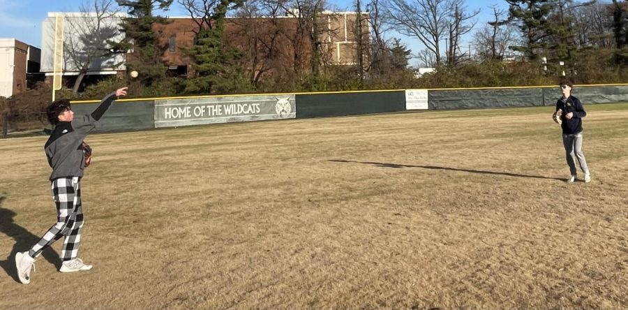 Varsity baseball players Brady Chan and Nolan Ross throw to get ready for this springs baseball season. The baseball field was renovated over the offseason and the new grass should help prevent injuries.