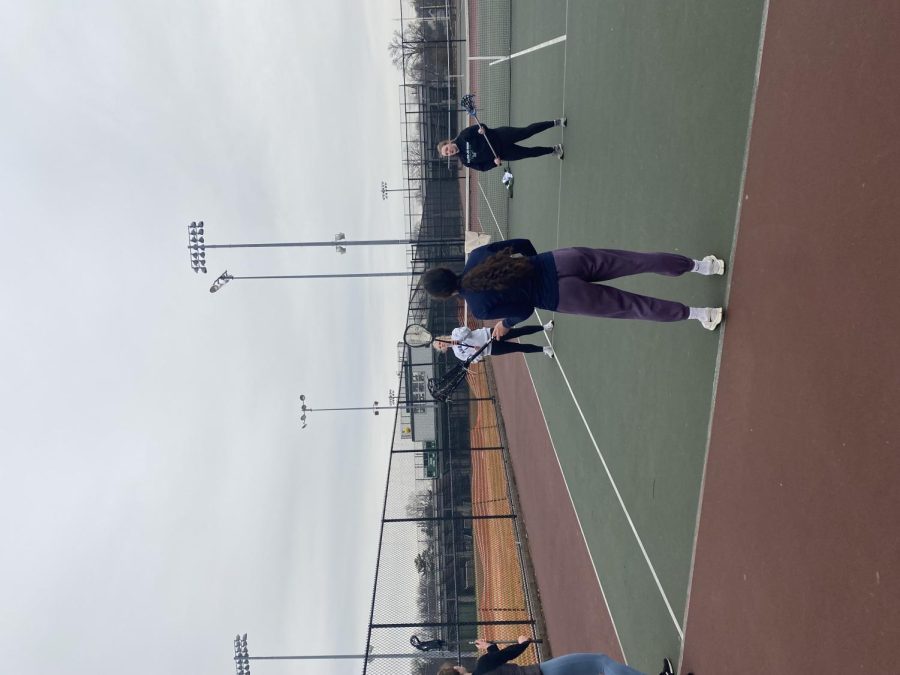 The winter girls lacrosse team practices on the WJ tennis courts for an upcoming game.