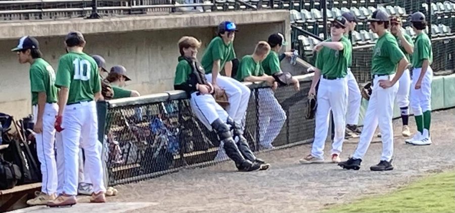 The fall JV baseball team discusses the previous inning in the dugout in their fall league game at Povich Field. Though not an official team sanctioned by MCPS, the Wildcats compete against other county and club teams.