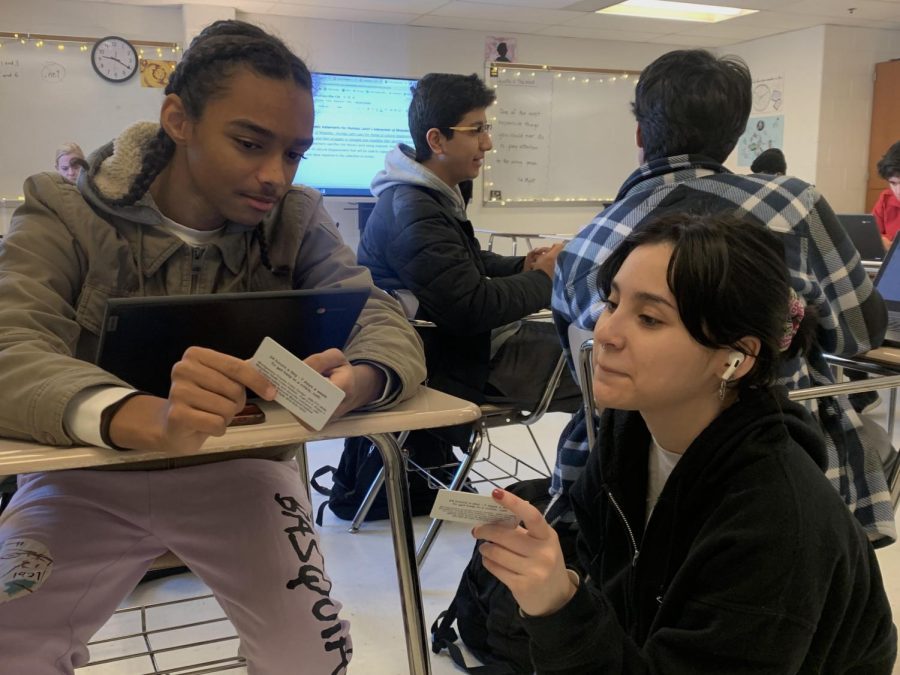 Seniors Stevie Gago and Matteo Palma show each other their newly taken senior portraits. The sessions for the portraits began in August and concluded in December.