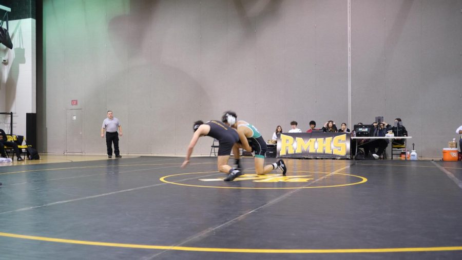 Senior Enzo Yamasaki wrestles against his opponent from Richard Montgomery. He was declared the winner by pin, contributing six points to the Wildcats.