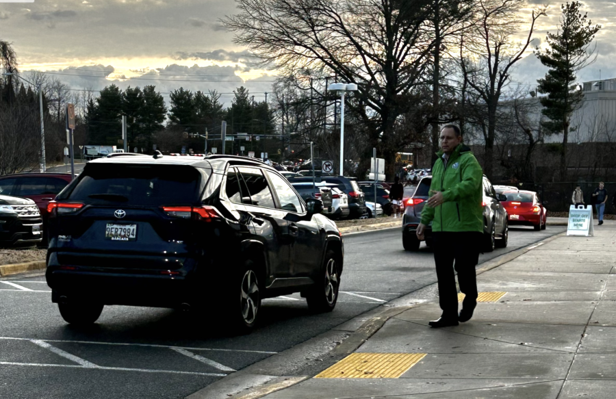 Assistant Principal Jeff Leaman directs traffic in the front loop during morning drop-off.  Agitation amongst drivers and pedestrians in the morning and afternoon creates a significant safety concern for students at WJ.