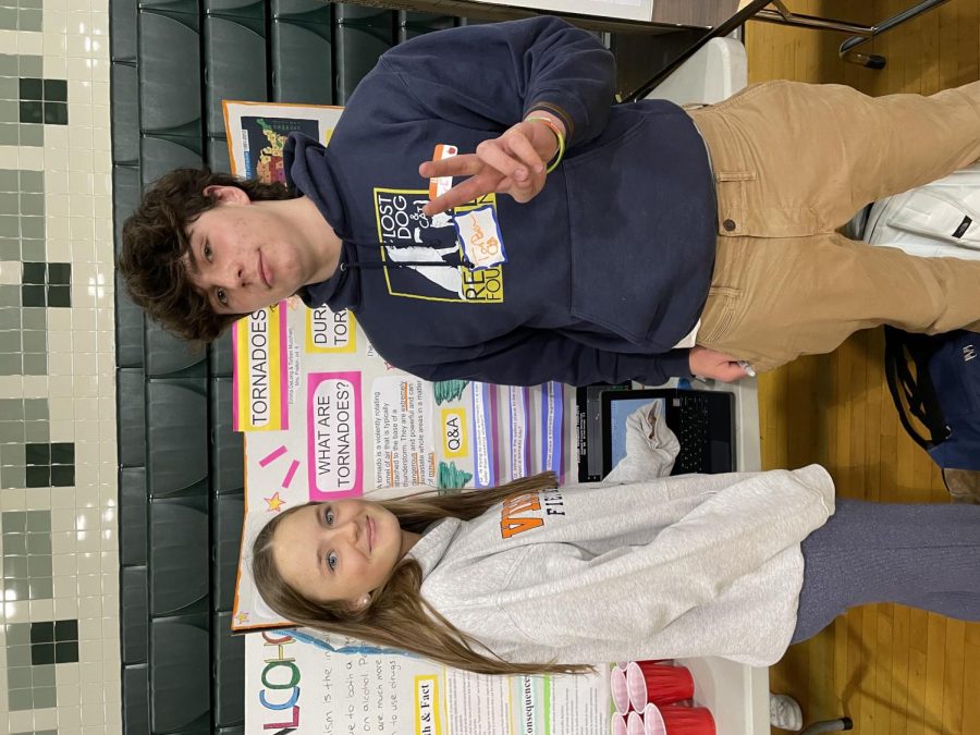 Juniors Emma DeLong and Torben Mucchetti educate students on the dangers of tornadoes and how to protect yourself from them. Make sure to stay inside and get under something sturdy, like a table, to stay safe, Mucchetti said.