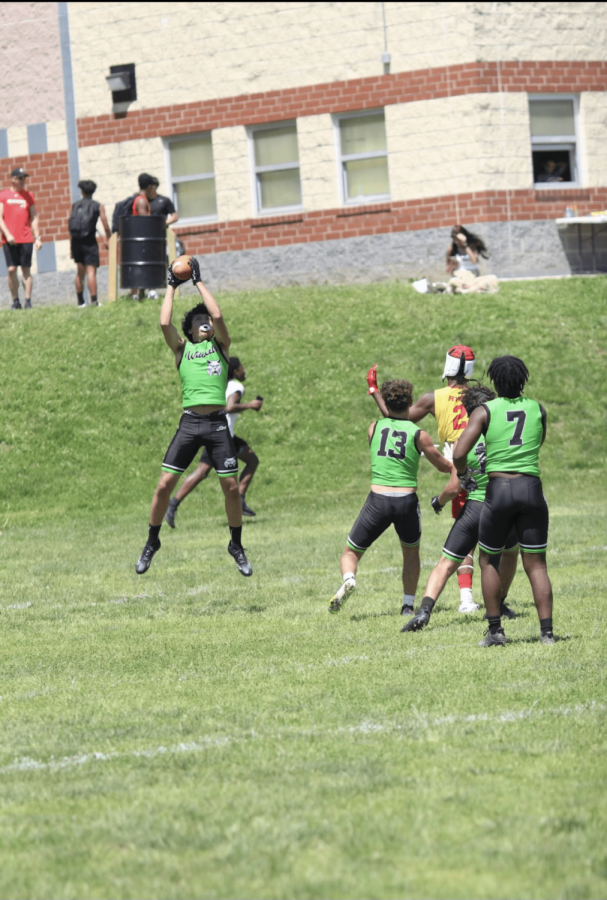 Senior Andre Gaskins goes up for a catch in footballs 7 on 7 summer league. The Wildcats use 7 on 7 games over the summer to prepare and build team chemistry for the regular season in the fall.