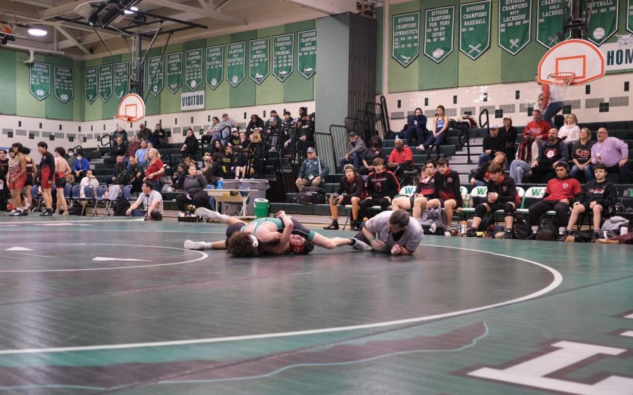 Sophomore+Dylan+Schoen+wrestles+against+his+counterpart+from+Quince+Orchard.+He+won+his+match+after+pinning+the+wrestler%2C+contributing+six+points+to+the+Wildcats+slight+victory.