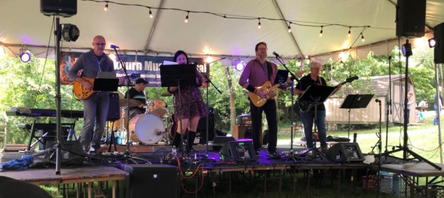 Veteran social studies teacher Mitchell Joy plays drums with his band, The Local. They play covers at a variety of events, including festivals and outdoor gigs.