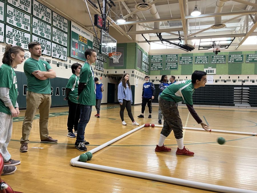 Senior Faisal Ali rolls the ball as his team watches behind him. Churchill walked away with the win after multiple competitive frames.