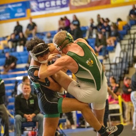 Senior Enzo Yamasaki throws down a wrestler in the third place match. Yamasaki has been a key component of the wrestling teams success this season.