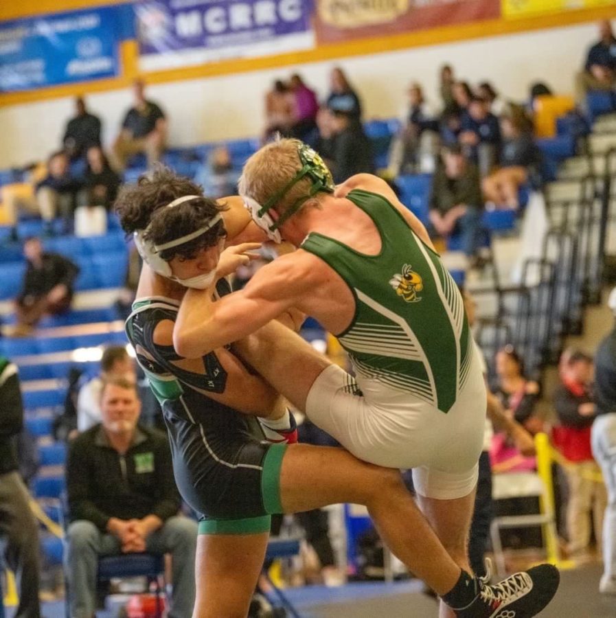 Senior+Enzo+Yamasaki+throws+down+a+wrestler+in+the+third+place+match.+Yamasaki+has+been+a+key+component+of+the+wrestling+teams+success+this+season.