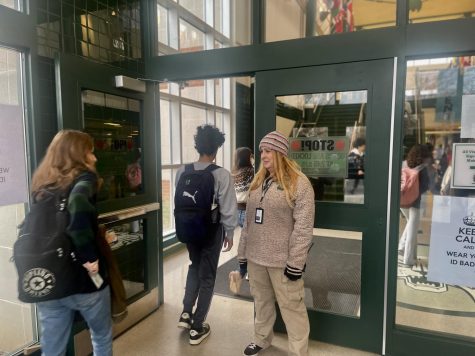 Security guard Kelly McDonnell checks students ID cards as they walk into the building in the morning. These checks are done before school and at lunch to ensure the safety of students in the building and are only part of the duties of the security guards at school.