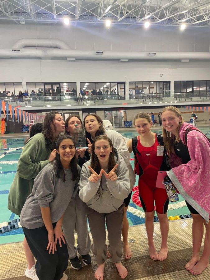 The girls swim and dive team celebrates their divisionals win. Their win came down to the last event where the 400 freestyle relay held their ground over BCC.