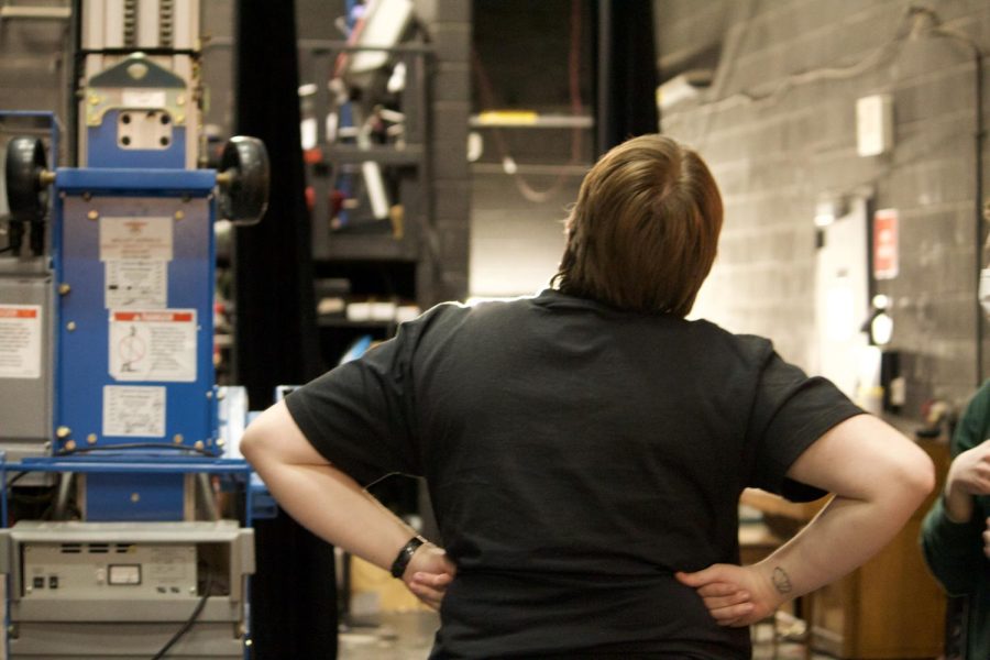 New technical director Mae Mironer looks up at the system of microphones and lights that hang above the stage. Having done everything from carpentry to lights work in the past, Mironer is well-suited to lead and mentor STAGE crew students.