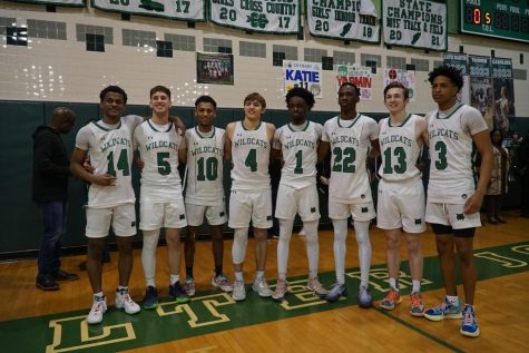 From left: Blake Bailey, Irad Zilberman, Aklilu, Dawson Carr, Parfait Seaswe, Dejohn Blunt, Archer Martin, Christion Wright. The seniors on boys basketball line up to take a picture as this is their last home game of the season.