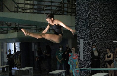 All eyes are on Arya Gupta as she performs a backwards dive at the regional diving championships last winter. “People stare but I take that as motivation, it is what fuels me to play well,” Gupta said.