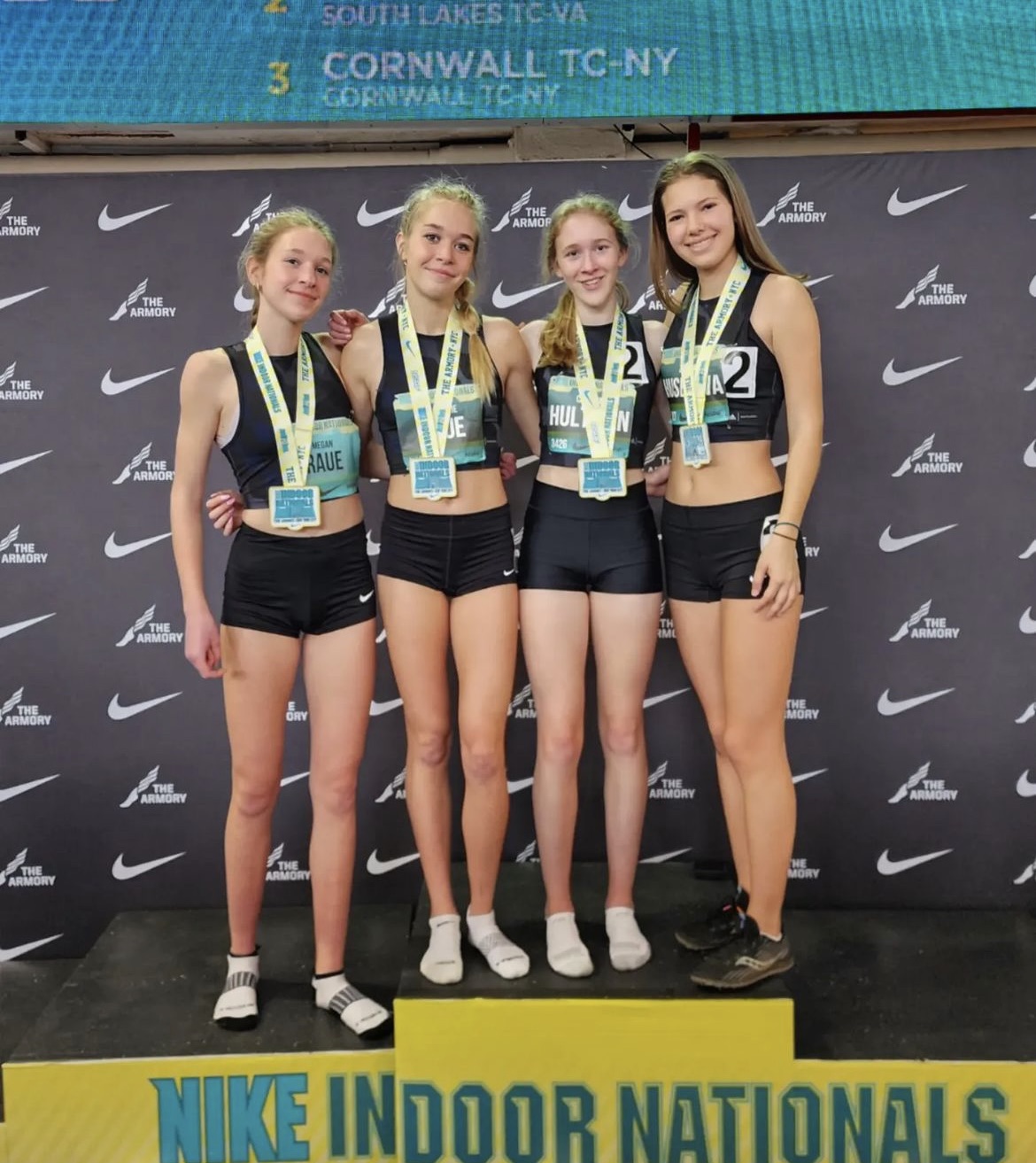 (From left) Megan Raue, Mackenzie Raue, Carolyn Hultman, and Zuzana Huserova strike a pose stop the podium at the 2023 Nike Indoor Nationals. The girls not only finished top five, but set a new personal and school record in the 4x800 and were also dubbed, All-Americans.