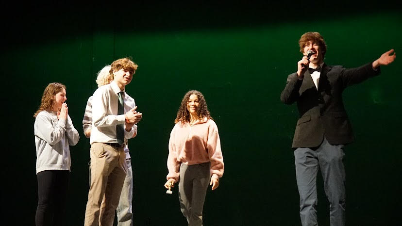 Theodore Dietrich announces Raina Pintos triumphant win of the golden cow trophy after competing in the WJ Talent Show.