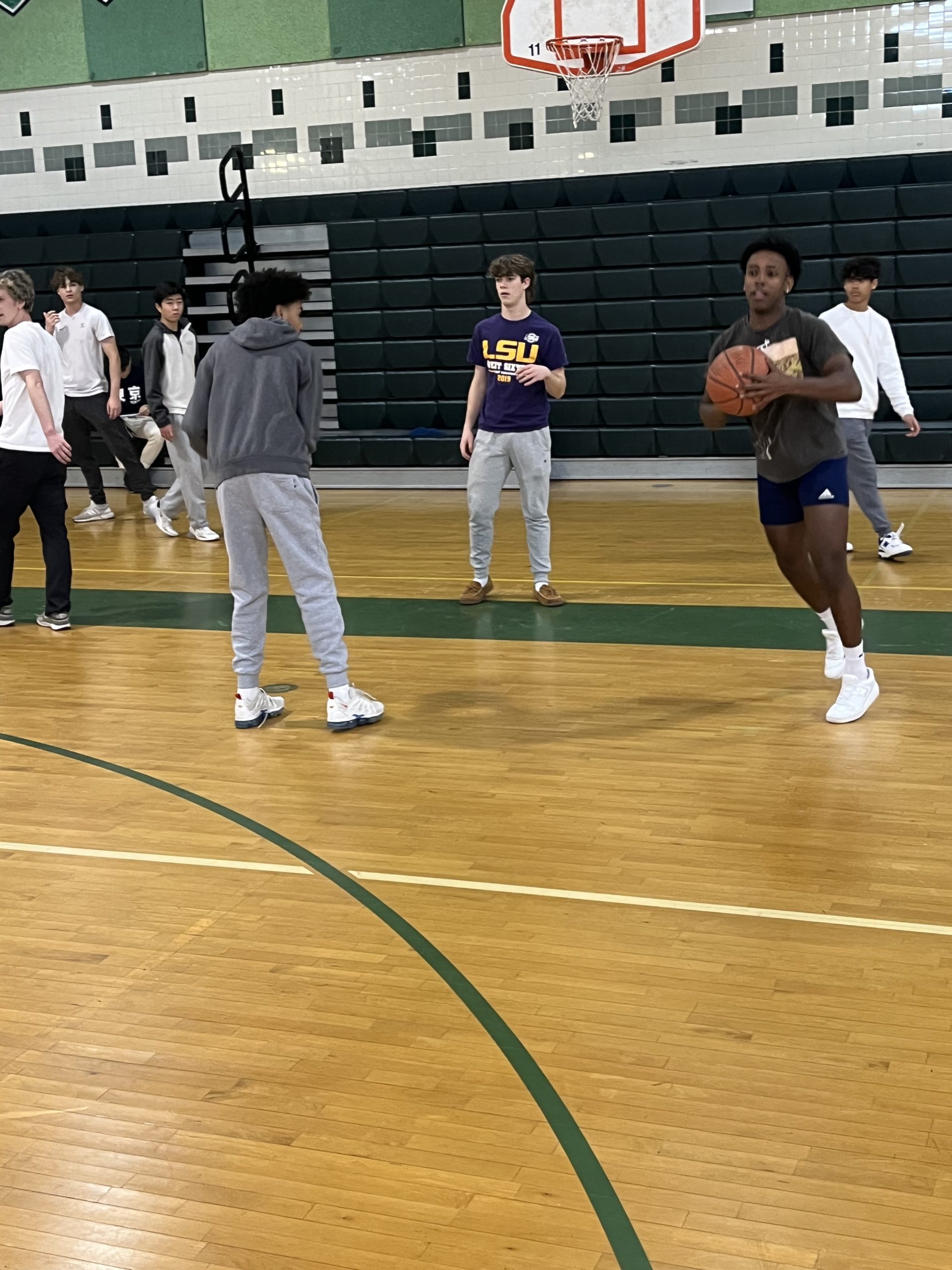 Ahmed Guggsa passes the basketball while Mr. Beswicks class shoots around ahead of the student-staff basketball game.