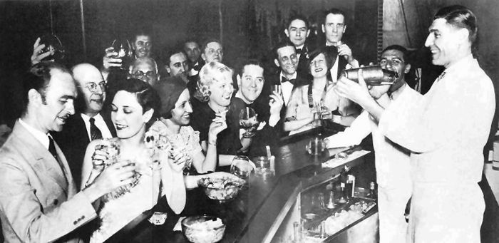 Senators pitcher and high school namesake Walter Johnson (right) performs bar tricks as a crowd gathers in a Baltimore speakeasy, circa 1930. While it may not be common knowledge today, Johnson was infamous for his homemade liquor business during Prohibition, and pioneering the creation of the mixed drink known as the Fastball.