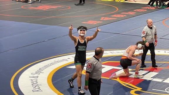 Senior Enzo Yamasaki celebrates his victory over Jacob Speed from Crofton High School in the fifth place match. He won four of his last five matches after losing in the opening round, finishing his season off strongly.