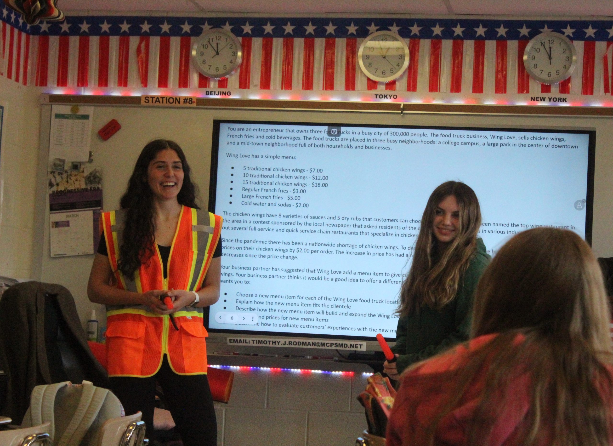 Junior vice president Daniela Znam and junior Amanda Simensky present a practice roleplay during the weekly DECA meeting. DECA meets every Friday at lunch in room 110.