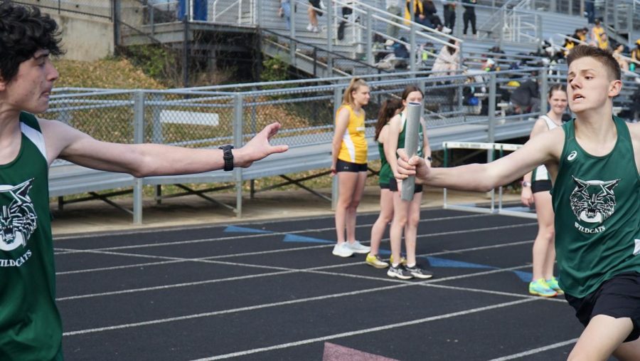 Freshman Grant Levens hands the baton off to sophomore Jonah Daniel. The boys track team won both the 4x400 and 4x800 meter relays against Richard Montgomery on Wednesday, March 22.