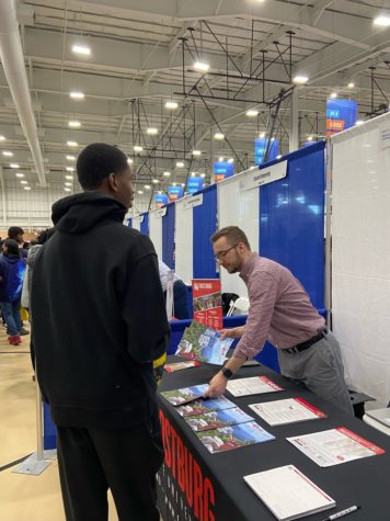 A student speaks with a representative from Frostburg State University. Long lines and large crowds plagued students attempting to learn about bigger and more popular schools such as UMD and Penn State.