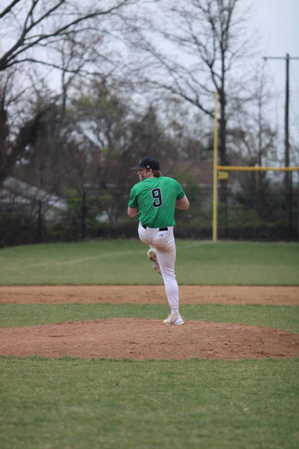 Captain Leo Simpson eyes the catcher, throwing a fastball. Simpson pitches and is a first baseman for the Wildcats.