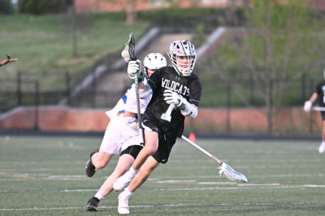 Junior captain and midfielder JR Dubose runs around a defender in a game against the Gaithersburg Trojans on April 19. The Wildcats defeated the Trojans 17-10 and added more victories the following week to improve their record to 5-4.