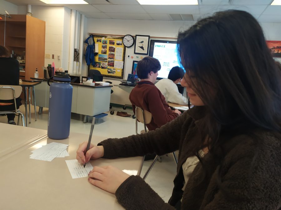 Junior Linh Nguyen creates flashcards with key dates and events for her AP World History exam.